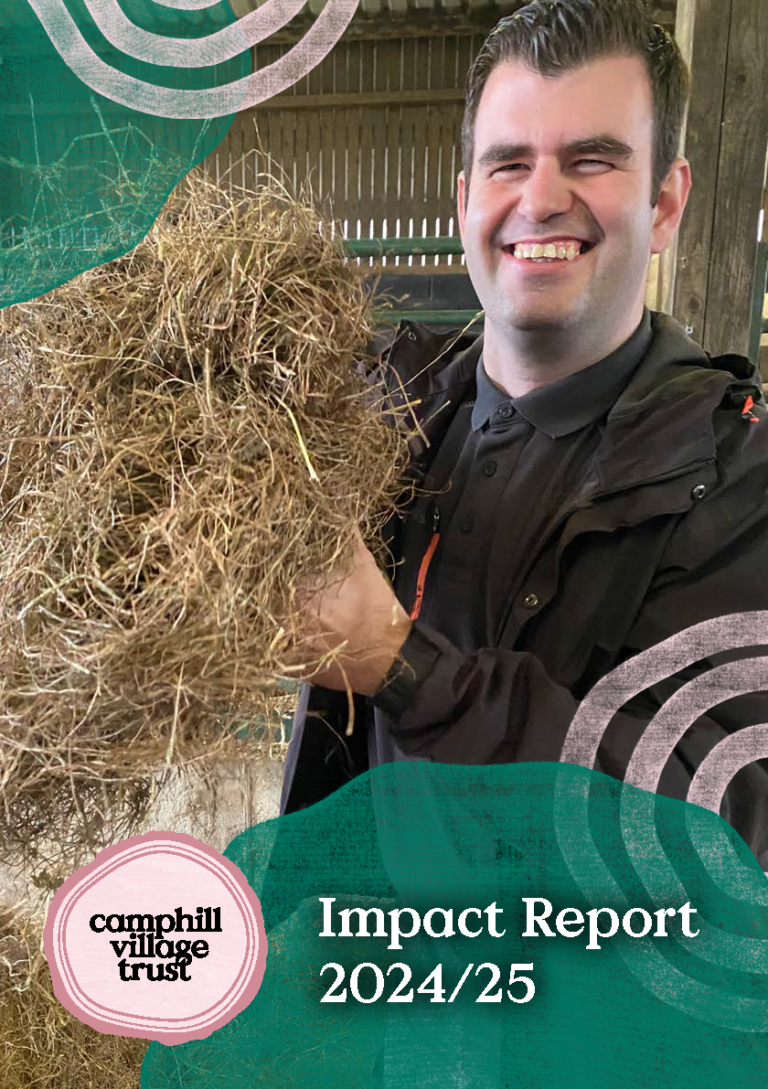 Front page showing a man in a barn holding up a bundle of hay and grinning at the camera.
